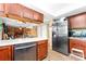 This kitchen features a stainless fridge, countertop and wood cabinets at 11416 Leadenhall Ln # 22, Charlotte, NC 28262