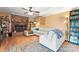 This living room features a fireplace, ceiling fan and wood floors at 11416 Leadenhall Ln # 22, Charlotte, NC 28262