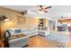 This living room features a spacious sectional couch, ceiling fan and wood floors at 11416 Leadenhall Ln # 22, Charlotte, NC 28262