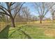 Large backyard features a new fence and mature trees at 1156 9Th St, Lancaster, SC 29720