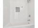 Modern white tiled bathtub with shower head and tiled wall niche at 1156 9Th St, Lancaster, SC 29720