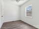 Bedroom featuring a window, wood-look laminate flooring, and light ceiling fan at 1156 9Th St, Lancaster, SC 29720