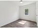 Well-lit bedroom with ceiling fan, window, and wood-look laminate flooring at 1156 9Th St, Lancaster, SC 29720