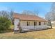 Charming home featuring a covered front porch, light colored siding, and a well-maintained lawn at 1156 9Th St, Lancaster, SC 29720