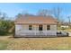 Charming home featuring a covered front porch, light colored siding, and a well-maintained lawn at 1156 9Th St, Lancaster, SC 29720
