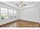 Bright, airy bedroom featuring hardwood floors, a tray ceiling and three windows at 1157 Bunch Dr, Statesville, NC 28677
