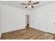 Bedroom with hardwood floors, a door leading to another room, and trimwork at 1157 Bunch Dr, Statesville, NC 28677