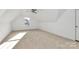 A sunlit upper bedroom with neutral carpet, a ceiling fan, and a window for fresh air and natural light at 1157 Bunch Dr, Statesville, NC 28677