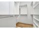 A bright walk-in closet features adjustable shelving and wood flooring, perfect for organizing your wardrobe at 1157 Bunch Dr, Statesville, NC 28677