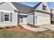 A well-manicured front exterior with landscaped flower beds, a gray front door, and a two-car garage at 1157 Bunch Dr, Statesville, NC 28677