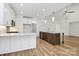 Kitchen with white cabinetry, stainless steel appliances, a kitchen island, and hardwood flooring at 1157 Bunch Dr, Statesville, NC 28677