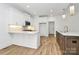 Bright kitchen featuring white cabinets, stainless steel appliances, marble countertops and wood flooring at 1157 Bunch Dr, Statesville, NC 28677