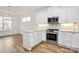Modern kitchen featuring white cabinets, stainless steel appliances, and beautiful backsplash at 1157 Bunch Dr, Statesville, NC 28677