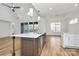 Beautiful kitchen with white cabinets, center island with sink, and stainless steel appliances at 1157 Bunch Dr, Statesville, NC 28677