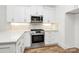 Modern kitchen featuring stainless steel appliances, subway tile backsplash, and ample countertop space at 1157 Bunch Dr, Statesville, NC 28677