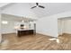 Bright living room open to kitchen featuring a ceiling fan, hardwood floors and vaulted ceilings at 1157 Bunch Dr, Statesville, NC 28677