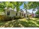 Inviting backyard with a patio, lush lawn, mature trees, and a shed in a partially shaded area at 1286 Saint Katherines Way, Rock Hill, SC 29732