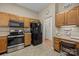The kitchen features wood cabinets, a microwave, oven, and a black refrigerator at 1286 Saint Katherines Way, Rock Hill, SC 29732