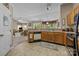 Charming kitchen features wood cabinets, tile floors, and views into the living room at 1286 Saint Katherines Way, Rock Hill, SC 29732
