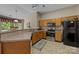 This cozy kitchen has wood cabinets and all-black appliances at 1286 Saint Katherines Way, Rock Hill, SC 29732
