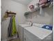 Convenient laundry room with a washer, dryer, and shelving for storage at 1286 Saint Katherines Way, Rock Hill, SC 29732