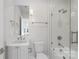 Stylish bathroom featuring a glass-enclosed shower and tub combo, elegant fixtures, and a modern vanity at 3115 Pinehurst Pl, Charlotte, NC 28209