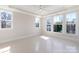 Sunlit bedroom showcases a tray ceiling and multiple windows offering neighborhood views at 3115 Pinehurst Pl, Charlotte, NC 28209