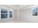 Bright bedroom featuring a ceiling fan, tray ceiling, and multiple windows at 3115 Pinehurst Pl, Charlotte, NC 28209