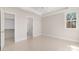 Bright bedroom with tray ceilings, a ceiling fan, an ensuite bathroom, and a large walk-in closet at 3115 Pinehurst Pl, Charlotte, NC 28209