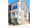 Beautiful three-story townhome with a mix of white siding, brick, and modern architectural details at 3115 Pinehurst Pl, Charlotte, NC 28209