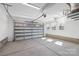 Spacious and well-lit two-car garage featuring a concrete floor, automatic door, and natural light at 3115 Pinehurst Pl, Charlotte, NC 28209