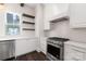 Modern kitchen featuring stainless steel appliances, granite countertops, and stylish open shelving at 3115 Pinehurst Pl, Charlotte, NC 28209