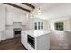 Modern kitchen with an island, stainless steel appliances, and seamless flow into the living area at 3115 Pinehurst Pl, Charlotte, NC 28209