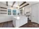Stunning white kitchen with a large island, stainless steel appliances, and stylish wooden beam accents at 3115 Pinehurst Pl, Charlotte, NC 28209