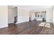 Open-concept living space showcasing hardwood floors and a view of the modern kitchen at 3115 Pinehurst Pl, Charlotte, NC 28209
