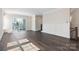 Spacious living room features hardwood floors, decorative wall paneling, and staircase access at 3115 Pinehurst Pl, Charlotte, NC 28209