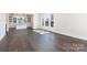 Sunlit living room displays hardwood floors, large windows, and views into the kitchen at 3115 Pinehurst Pl, Charlotte, NC 28209