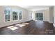 Bright living room boasts hardwood floors, large windows, and a sliding door to a patio at 3115 Pinehurst Pl, Charlotte, NC 28209