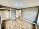 Bedroom with laminate floors, a closet with open door, and neutral gray paint at 132 Pisgah Church Rd, Statesville, NC 28625