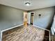 Bedroom featuring wood laminate flooring, closet with open door, and neutral gray paint at 132 Pisgah Church Rd, Statesville, NC 28625