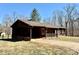 Rustic exterior of home with brown siding, a covered porch, and a well-maintained lawn at 132 Pisgah Church Rd, Statesville, NC 28625