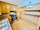 Kitchen with wooden cabinets, laminate floors, stainless steel oven, and adjacent dining area at 132 Pisgah Church Rd, Statesville, NC 28625