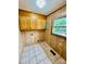 Functional laundry room featuring durable tile flooring, built-in cabinets, and a window for natural light at 132 Pisgah Church Rd, Statesville, NC 28625