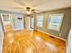 Cozy living room featuring wood floors, two windows, and a ceiling fan at 132 Pisgah Church Rd, Statesville, NC 28625