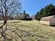 Large backyard with a home, green lawn, mature trees, and a storage shed at 132 Pisgah Church Rd, Statesville, NC 28625