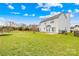 Spacious backyard featuring green grass, patio, and a privacy fence at 13705 Queenswater Ln, Charlotte, NC 28273