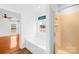 Contemporary bathroom features a tub, walk-in shower, and windows for natural light at 13705 Queenswater Ln, Charlotte, NC 28273
