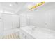 Well-lit bathroom featuring white vanity, shower-tub, and large mirror at 13705 Queenswater Ln, Charlotte, NC 28273