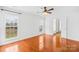 Bright bedroom showcases hardwood floors, neutral walls, and a window providing a view of the backyard at 13705 Queenswater Ln, Charlotte, NC 28273