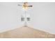 Bright bedroom features neutral carpet, ceiling fan, and natural light at 13705 Queenswater Ln, Charlotte, NC 28273